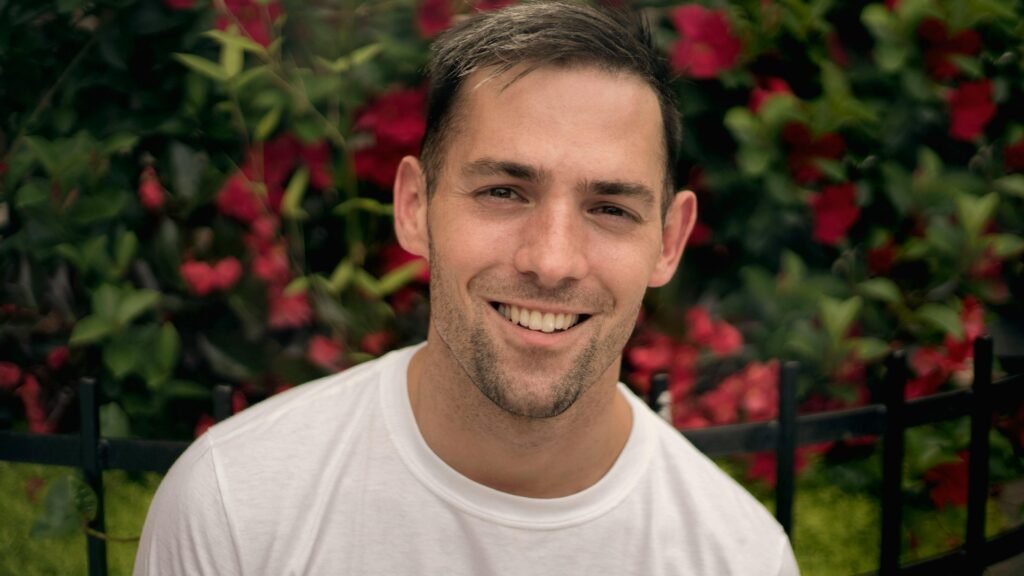 A smiling man with glowing skin after using a serum